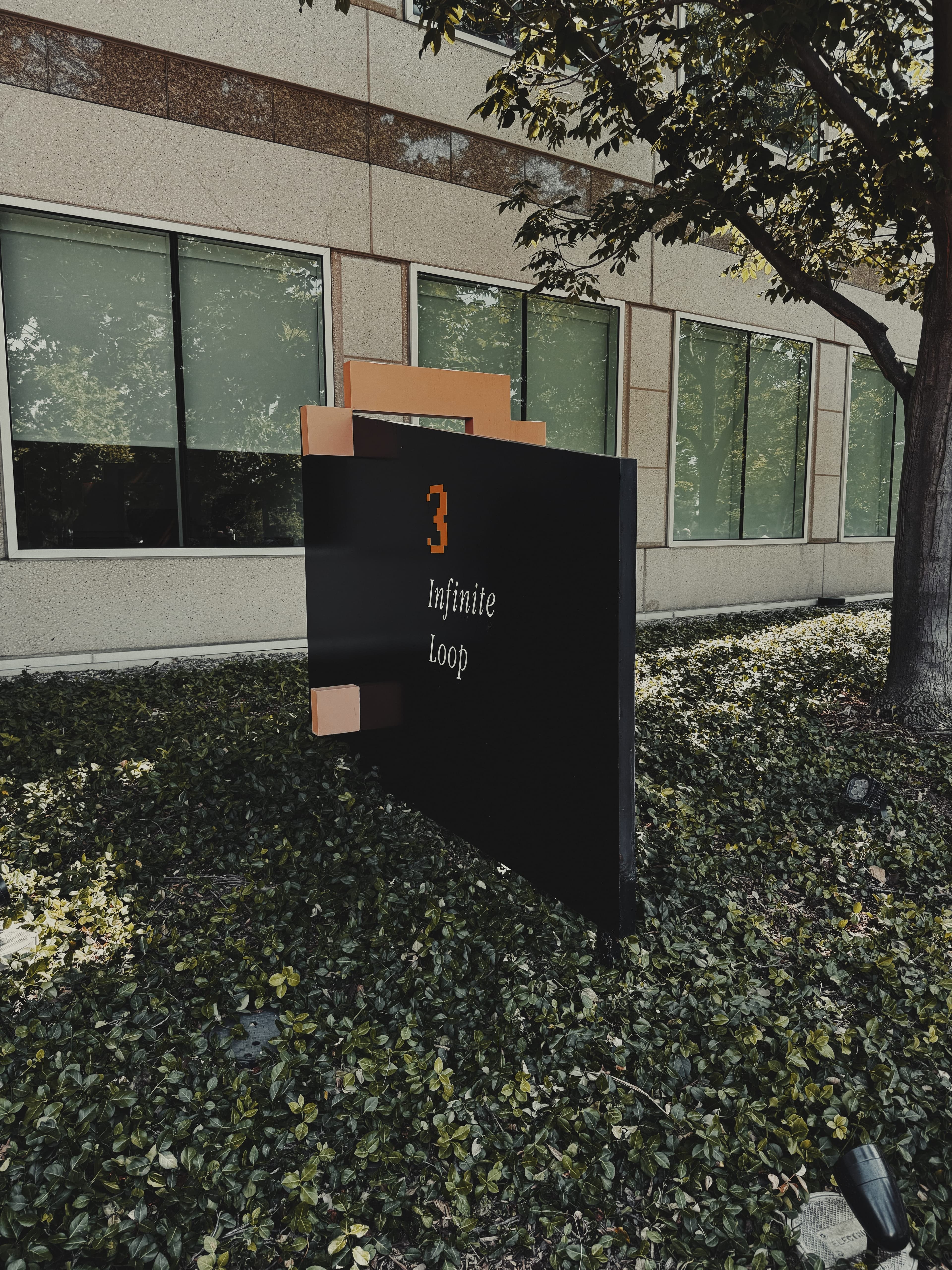 A photograph of the 3 Infinite Loop sign at Apple Campus.